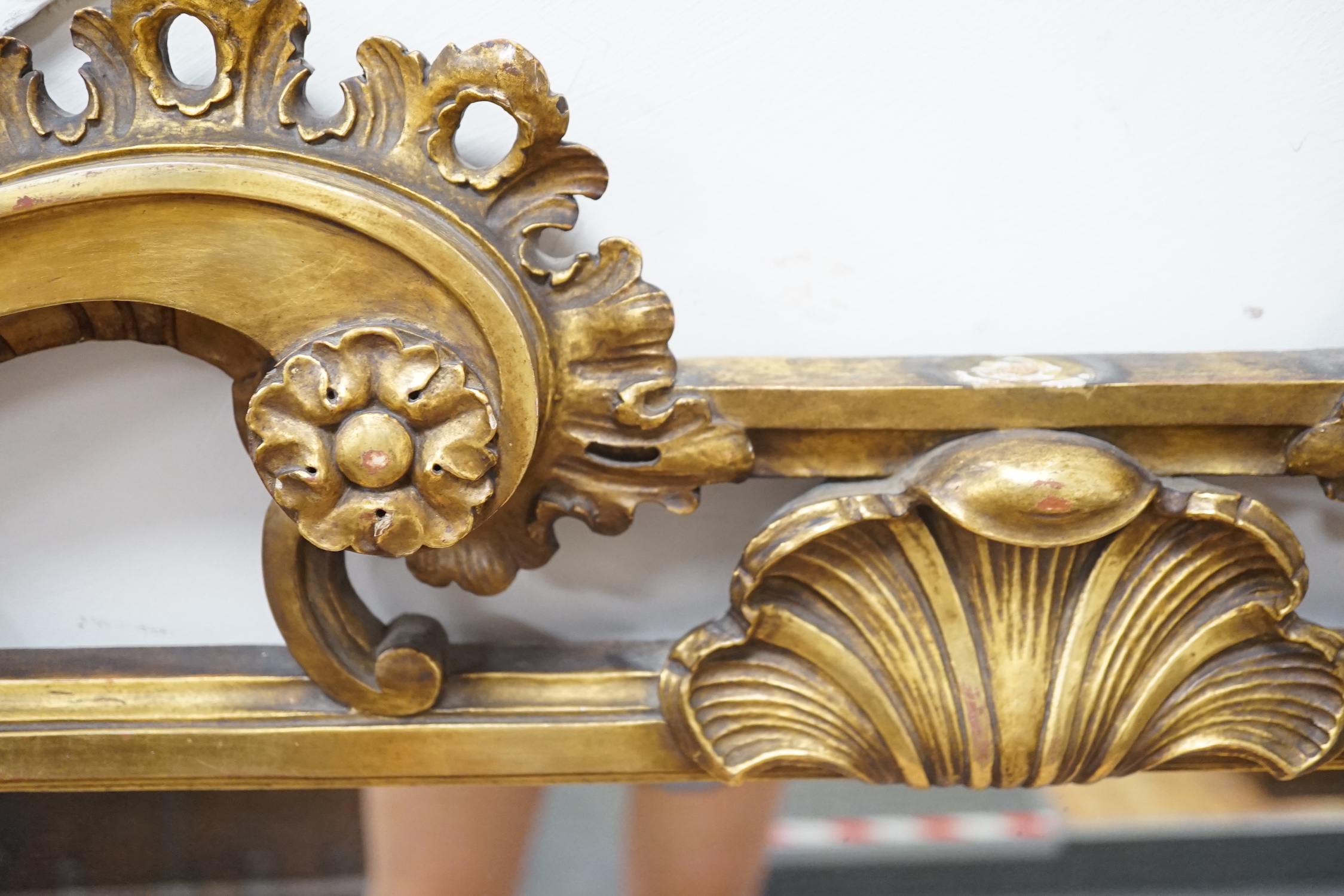 A rococo revival carved giltwood landscape mirror, width 160cm, height 113cm